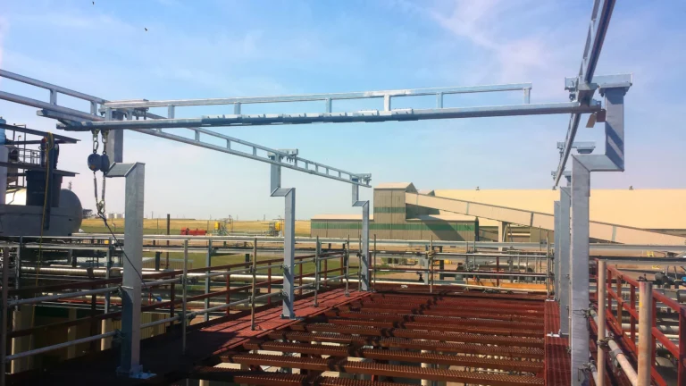 Galvanized overhead rigid rail above an outdoor loading rack